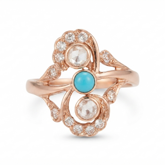 A rose gold ring with a sculptural Victorian design, featuring a central round turquoise cabochon and two round clear diamond gemstones surrounded by small diamonds, set against a plain white background.