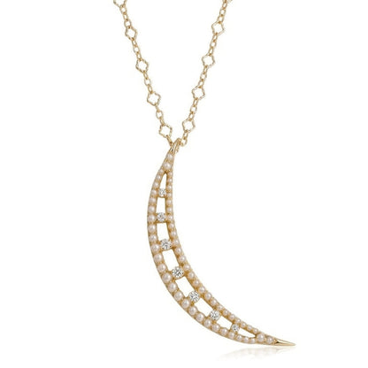 Delicate gold necklace with a crescent moon pendant on a white background